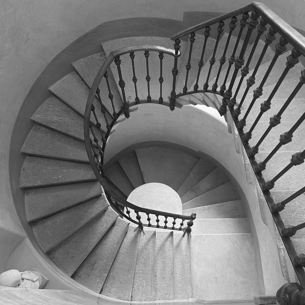 Black and white architectural spiral staircase illustrating a confusing narrative, by Portland life coach Mark Newton.